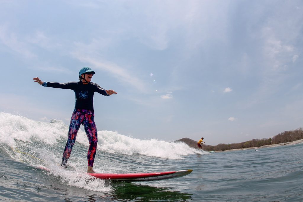 Women having fun and surfing on the water