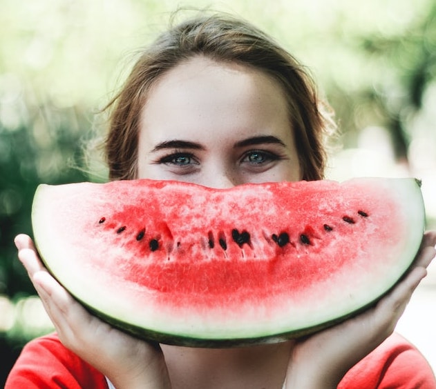 woman eating watermelon for hydration