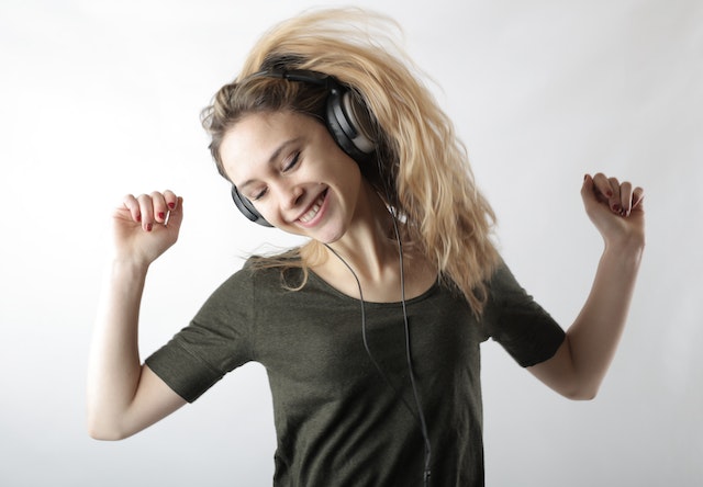 woman listening to upbeat music in morning