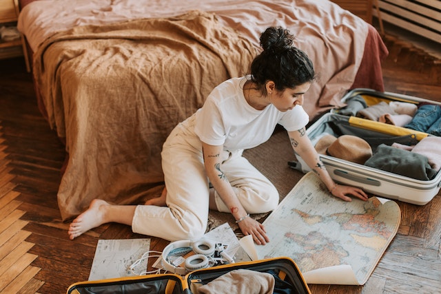 Woman packing and looking at a map.