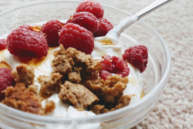 Greek yogurt with biscuit crumb and fresh raspberries